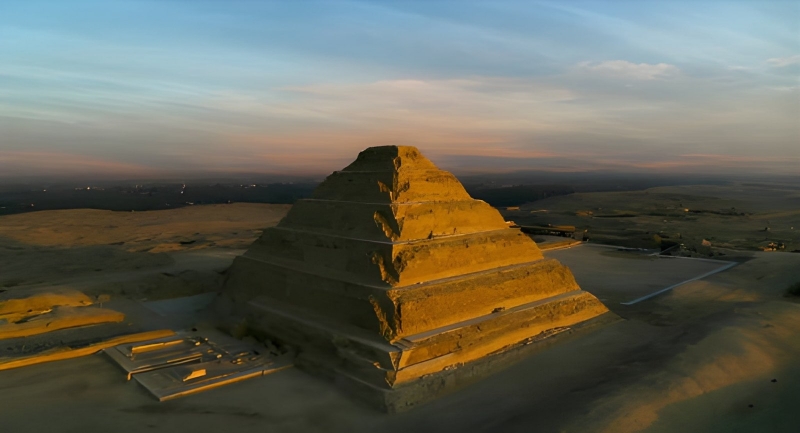 Step pyramid rising from the desert at dusk