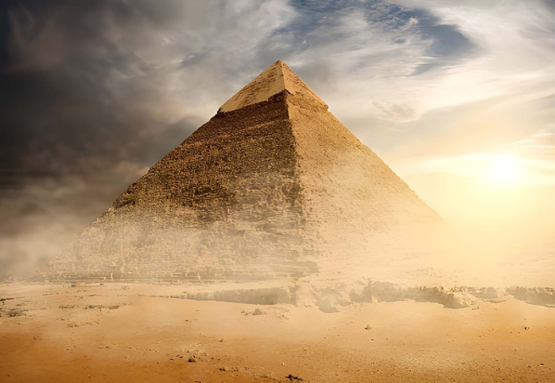 Giza pyramid at sunset A pyramid at Giza glowing under a dramatic sky at sunset