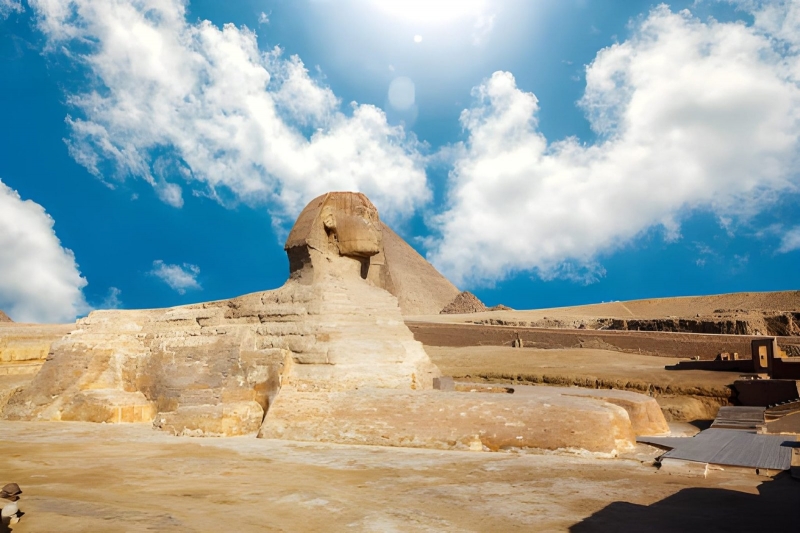 The Great Sphinx of Giza under a blue sky with clouds