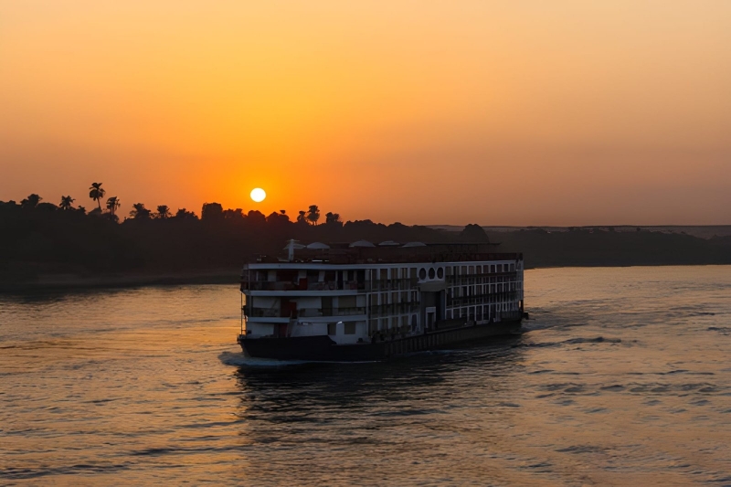 A Nile cruise ship sailing at sunset