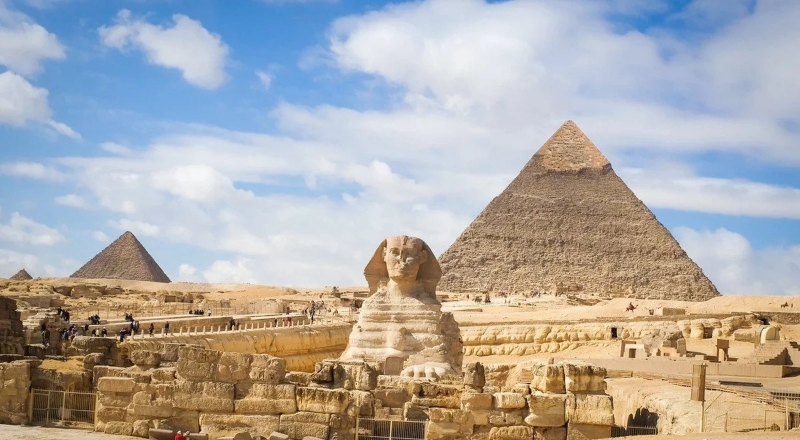 Giza pyramids and the Sphinx under a blue sky